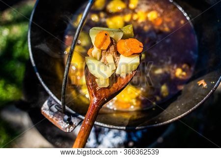 traditional Hungarian gulash soup (bogrÃ¡cs gulyÃ¡s) in a pot over fire