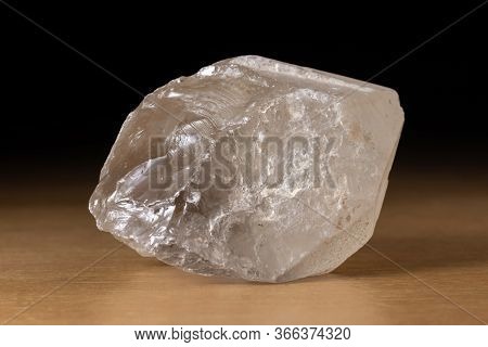 Translucent Smoky Quartz Mineral From Brazil Over A Wooden Table