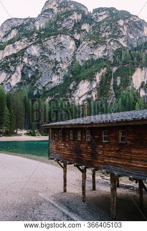 Wooden Boat Dock Hut On The Lago Di Braies On The Background Of Rocky Mountains And Forests. Braies 