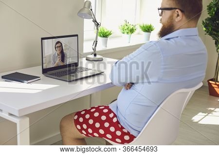 Online Work At Home. Funny Fat Businessman In Red Shorts Works Communicates Video Chat Call Using La