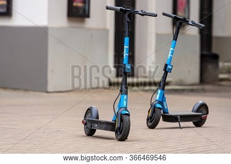 Riga, Latvia - May 14, 2020: Two Dockless Rental Electric Scooters Is Parked On The Sidewalk, Ecolog