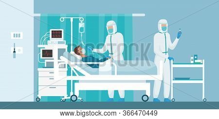 Expert Doctors Wearing Protective Suits And Healping A Patient With Coronavirus Lying In A Hospital 