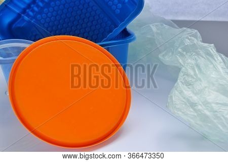 Orange Lid, Transparent And Blue Plastic Container On A White Background. Chemist Day. International