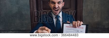 Panoramic Orientation Of Angry Collector With Documents With Foreclosure Lettering Pointing With Fin