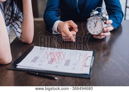 Cropped View Of Collector With Alarm Clock Pointing At Documents With Foreclosure And Final Notice L