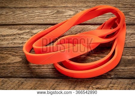 resistance exercise band for fitness and rehabilitation against wooden background