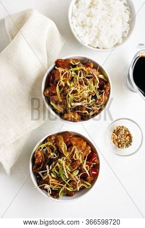 Spicy Garlic Fried Chicken (kkanpunggi). Asian Chicken In Sweet And Sour Sauce In Bowl Over White Ba