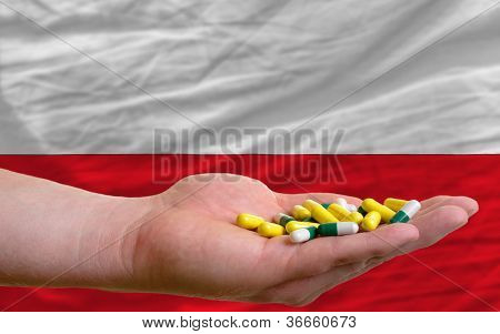 Holder piller i hånden foran Polen nationale Flag