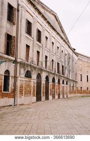 Venice, Italy - 04 October 2019: A Deserted Street Of Venice, Italy. Facade Of The Building Of The S