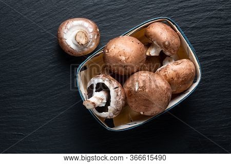 Helathy Food Concept Organic Cremini Brown Mushrooms On Black Slate Board Backgroun With Copy Space