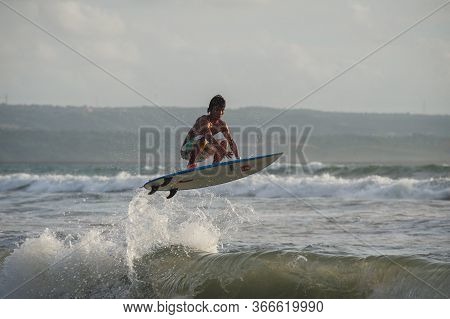 Bali, Indonesia-march 2020: Young People Ride On Short Boards On The Waves. Extreme Jump, Sports And