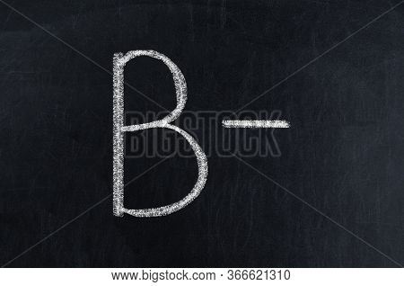 Blackboard With White Chalk Writing Showing Grade B-.