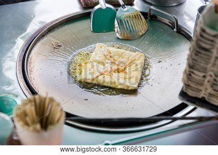 Roti Making, Roti Thresh Flour By Roti Maker With Oil. Indian Traditional Street Food. Thai Pancake 