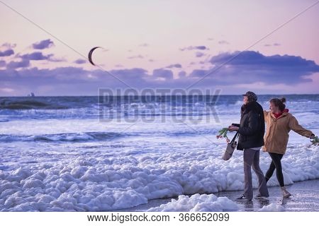 Scheveningen, May 14 2020: Scheveningen, The Netherlands. Two Women Emotionally Throw Flowers In The