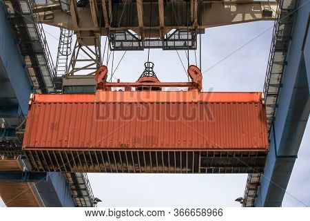 Crane Moving A Shipping Container To A Storage Platform.