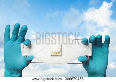 Doctor Hands Showing N99 Or Ffp3 Protective Mask On Sky Clouds Background