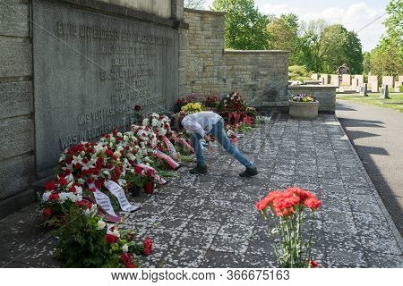 Seelow, Germany - May 09, 2020: A Boy Lays Flowers At The Foot Of The Monument To Soviet Soldiers At