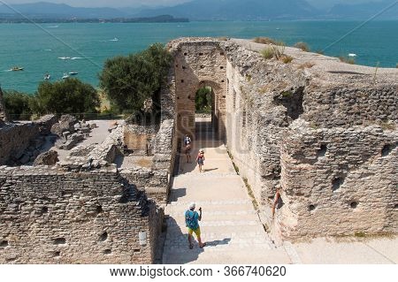 Italy, Lombardy - August 05 2018: The View Of Roman Ruins Grotte Di Catullo With Lake Garda On Backg