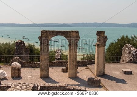 Italy, Lombardy - August 05 2018: The View Of Roman Ruins Grotte Di Catullo With Lake Garda On Backg