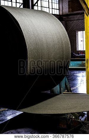 Close Up Of A Roll Of Rubber On A Machine In A Conveyor Belt Factory