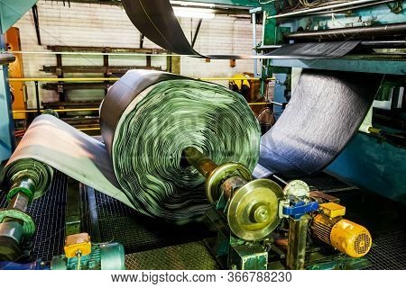 Close Up Of A Roll Of Rubber On A Machine In A Conveyor Belt Factory