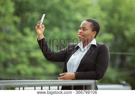 Selfie, Videocall. African-american Businesswoman In Office Attire Smiling, Looks Confident And Happ