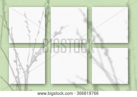 6 Square Sheets Of White Textured Paper On The Light Green Wall Background. Mockup Overlay With The 