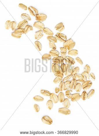 Oat Flakes Isolated On White Background. Falling Oats Macro. Oatmeal Top View