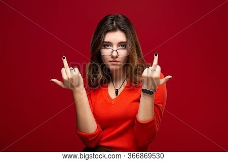 Young Female Student In Glasses Shows Indecent Gestures Middle Finger, Provocation Concept. Isolated
