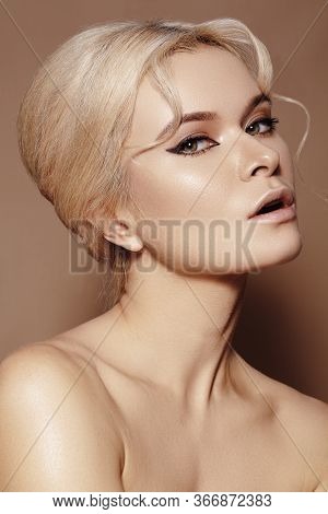 Sexy Model With Retro Make-up, Clean Skin, Blond Hair On Beige Background. Elegant Woman With Fashio