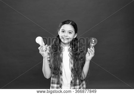 Eco Life. Lighting Choice. Little Girl Light Bulbs On Red Background. Symbol Of Idea Progress And In