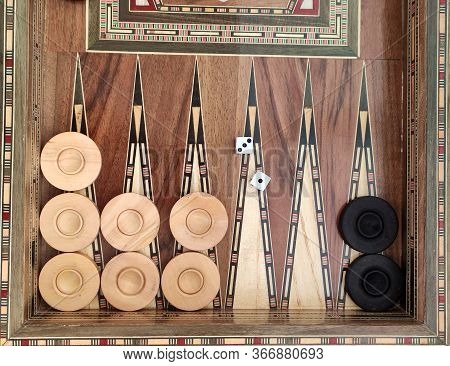 Backgammon With Wooden Inlay. Wooden Backgammon Board Game Of Pearl Inlaid On Brown Background.