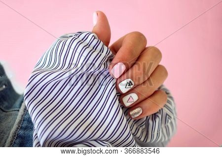Female Hands With A Beautiful Manicure On A Pink Background.