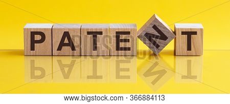 Patent - Word From Wooden Blocks With Letters, Concept, Yellow Background.