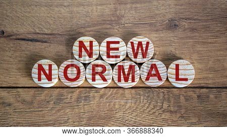New Normal Word On Wooden Alphabet Circles. New Normal Concept. Beautiful Wooden Background.