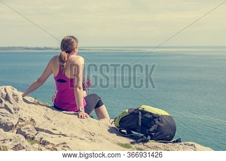 Active Woman Sitting And Enjoying Sea View. Living Life And Meditating.