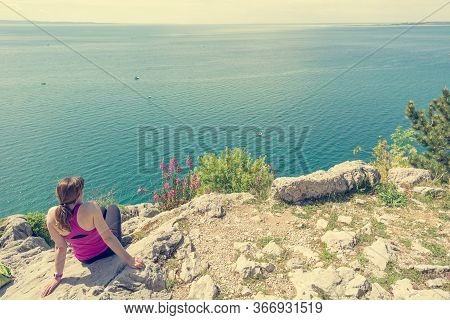 Active Woman Sitting And Enjoying Sea View. Living Life And Meditating.