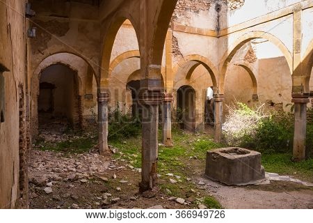 One Of Many Yards In An Abandoned House. Arcade With Arcs On A Columns. Base Of A Former Fountain. G