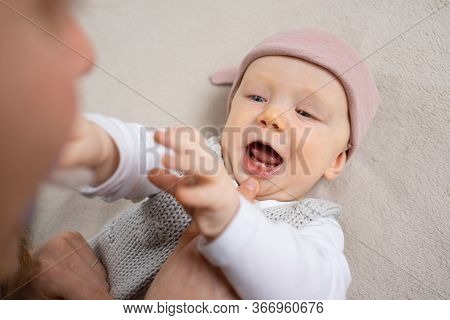 Mom Checking Two Teeth In Baby Daughter Mouth. Mother And Little Child Staying At Home. Child Care O