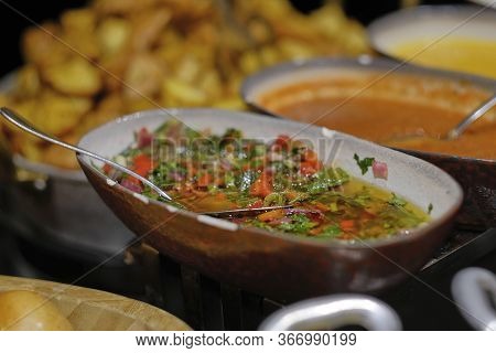 Chimichuri Sauce In A Borderous Oblong Plate On A Table With Other Sauces And Baked Potatoes In The 
