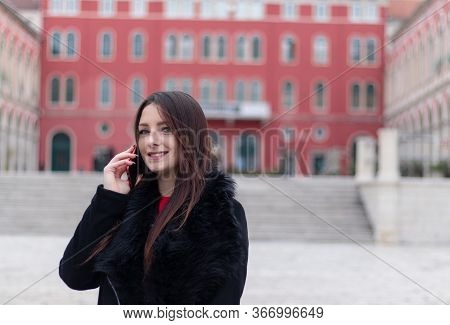Confident Attractive Brunette Standing In Public , 
