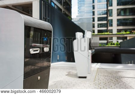 Parking Meters On City Street Near Buildings