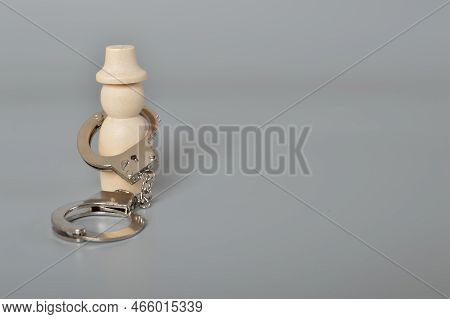 Wooden People Of Figure With Handcuff Locked. Handcuffed Convict, Law Offender And Justice Concept.
