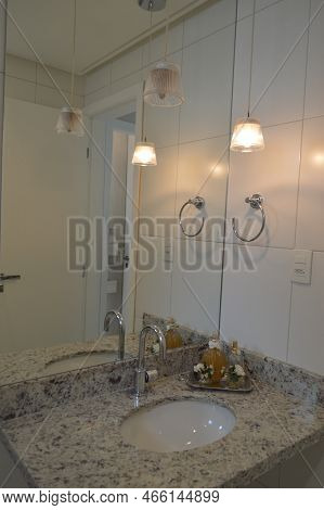Cozy Bathroom With White Tiled Walls And Granite Sink With Beautiful