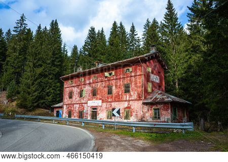 Comelico Superiore, Italy - November 3, 2022: Abandoned Red State House On Carnica Road In Italy