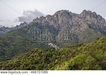 The Mountain Village Of Popolasca In Corsica With Les Aiguilles De Popolasca Behind Dusted In Snow