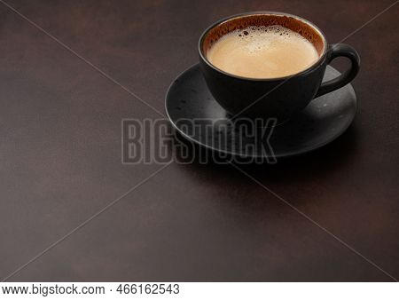 Large Cup Of Fresh Hot Coffee With Creamy Foam On Brown Board.