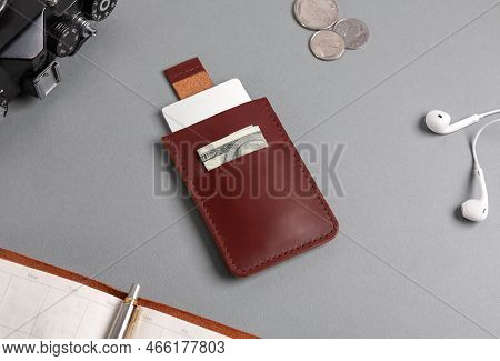 Leather Cardholder With Dollars And Cards On The Table.
