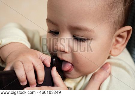 Cute Adorable Newborn Baby Playing With Colorful Rattle Toy. Baby With Teether. Six Months Old Lovel
