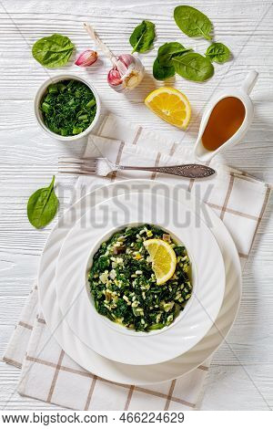 Spanakorizo, Greek Spinach And Rice Pilaf With Lemon, Dill, Scalion In White Bowl On White Textured 
